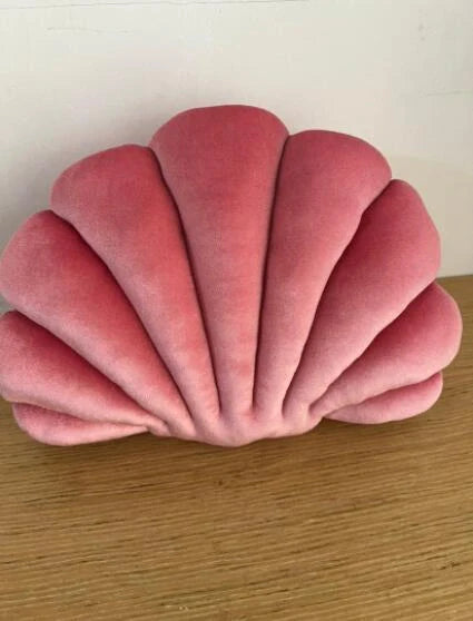 Cosy shell-shaped plush nap pillow in various colours and sizes for ultimate comfort