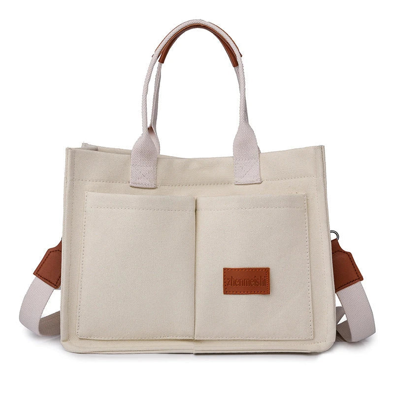 Stylish and durable canvas tote bag with multiple pockets for everyday use