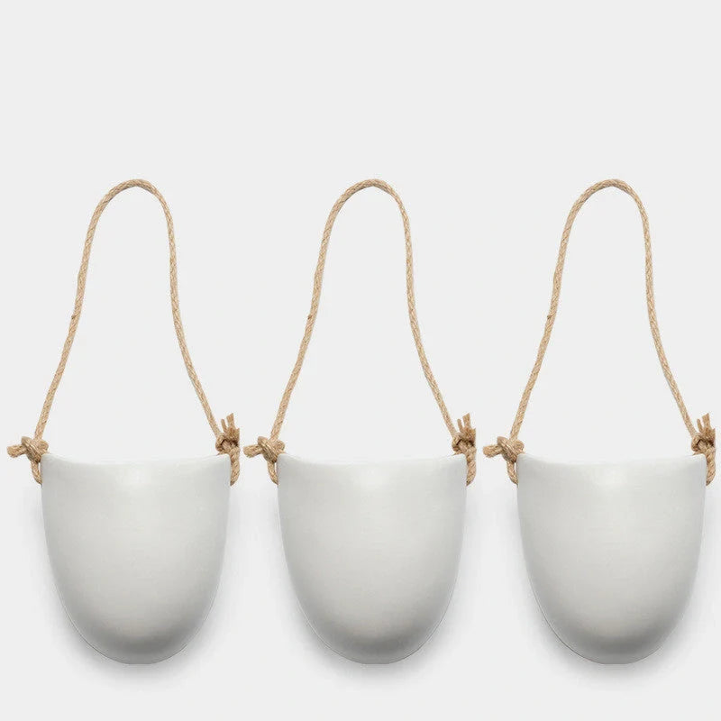 Wall-mounted ceramic flower pot in matte white with hemp rope for balcony gardening