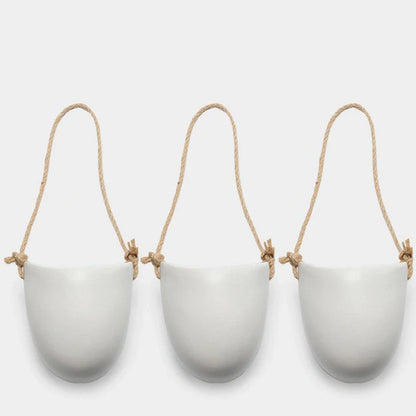 Wall-mounted ceramic flower pot in matte white with hemp rope for balcony gardening