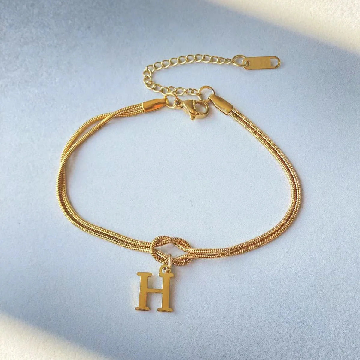 Personalised gold and silver love knot bracelets for couples, perfect as Valentine's Day gifts.