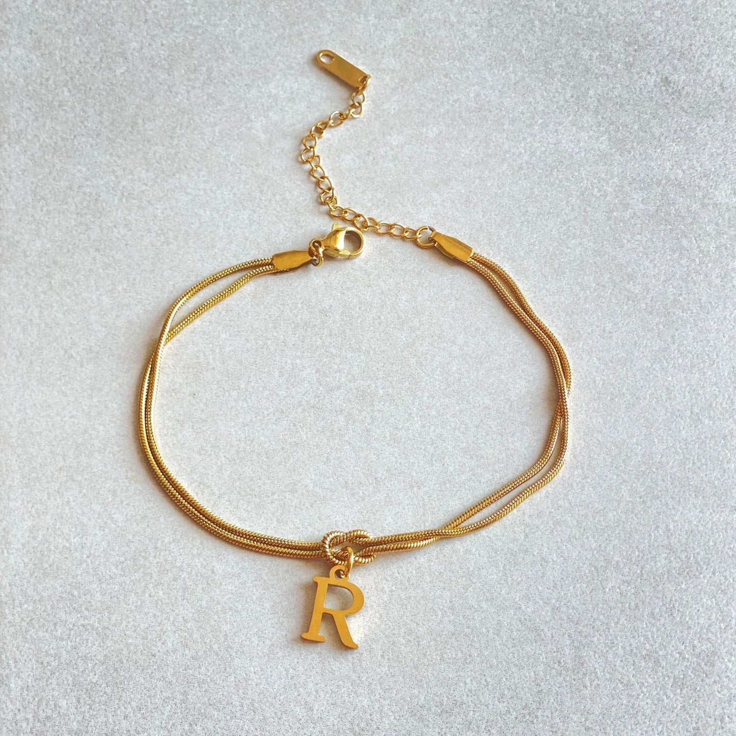 Personalised gold and silver love knot bracelets for couples, perfect as Valentine's Day gifts.
