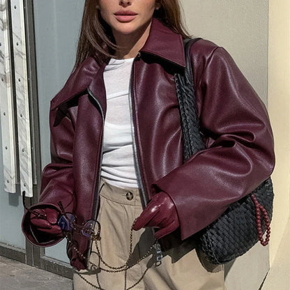 Fashionable faux leather jacket in burgundy and black colors, featuring a zipper closure and long sleeves for casual, versatile wear