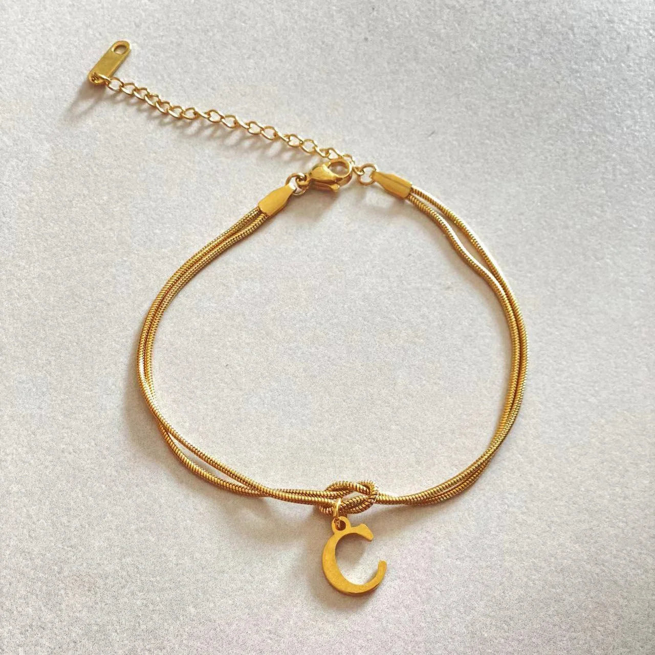 Personalised gold and silver love knot bracelets for couples, perfect as Valentine's Day gifts.