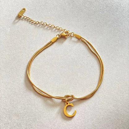 Personalised gold and silver love knot bracelets for couples, perfect as Valentine's Day gifts.