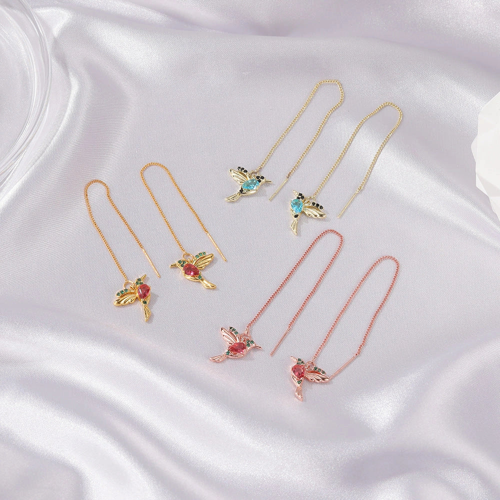 Elegant hummingbird drop earrings with crystal accents, a versatile fashion accessory for British women