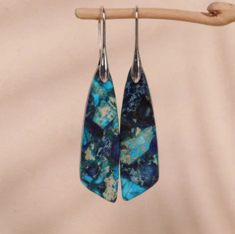 Geometric flower shape pendant earrings in copper with gold hooks, available in red, green, and blue.