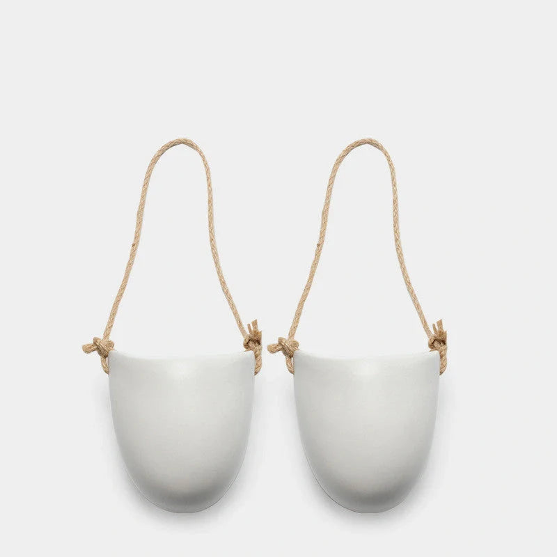 Wall-mounted ceramic flower pot in matte white with hemp rope for balcony gardening