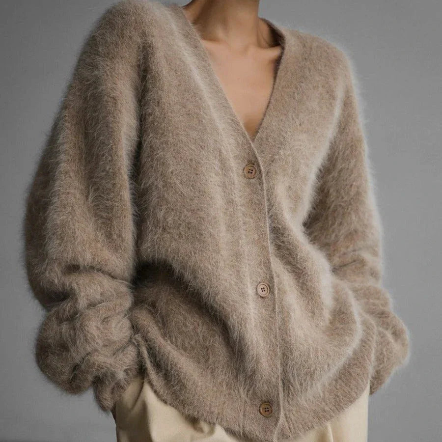 A stylish loose knit cardigan in a variety of colors, featuring a v-neck design and single-breasted closure for a flattering, relaxed fit.
