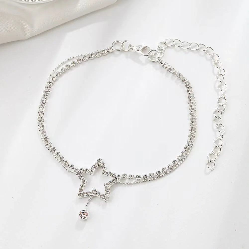 Sparkling star-shaped rhinestone necklace and anklet jewellery set in gold and silver tones