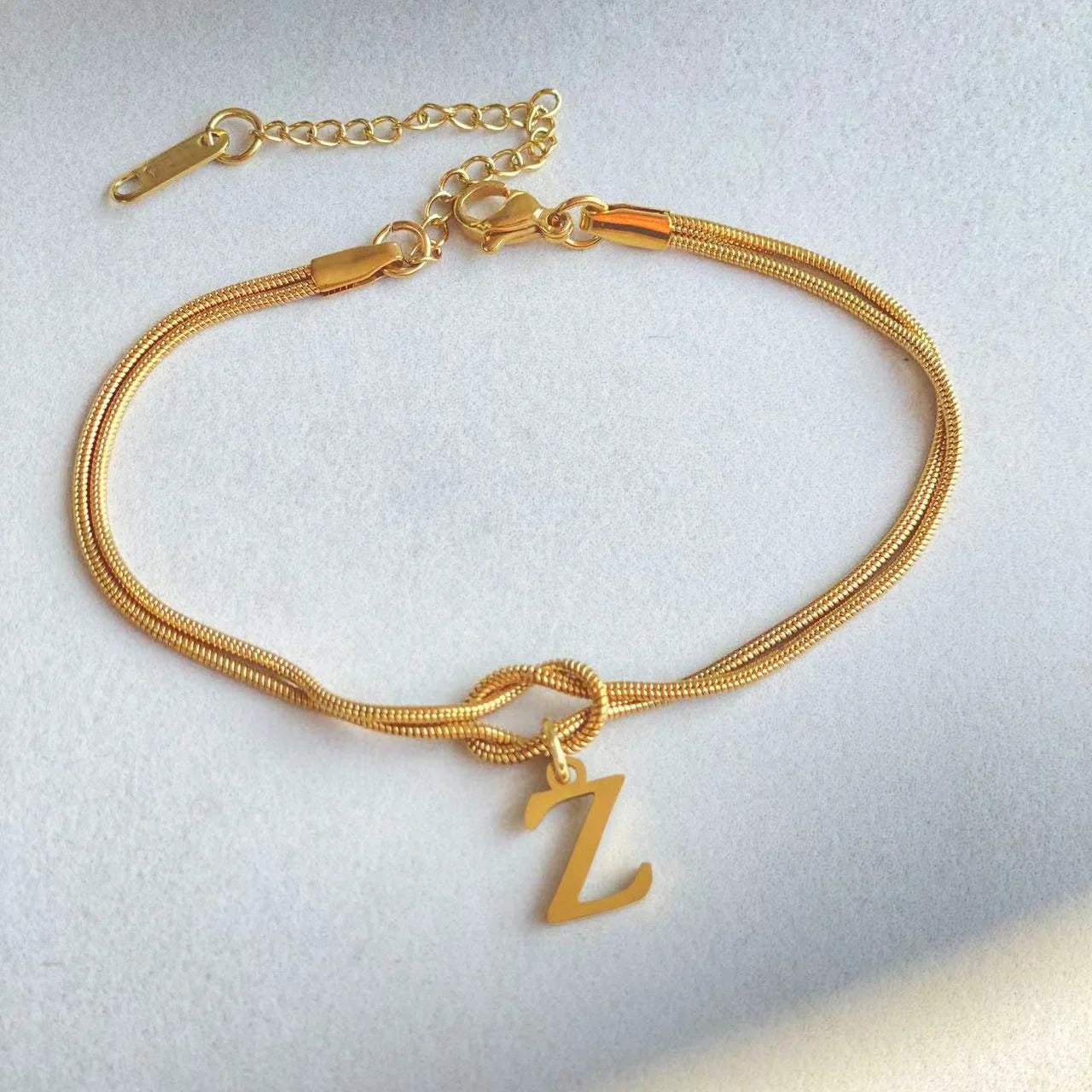 Personalised gold and silver love knot bracelets for couples, perfect as Valentine's Day gifts.