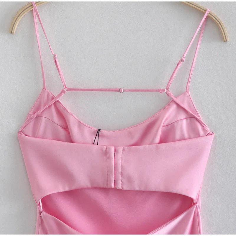 A sleek and elegant satin slip dress in a stunning pink color with a backless design and full-length silhouette.