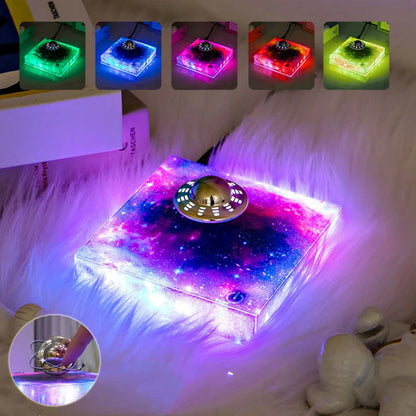 Futuristic levitating UFO lamp with color-changing lights and Milky Way galaxy base