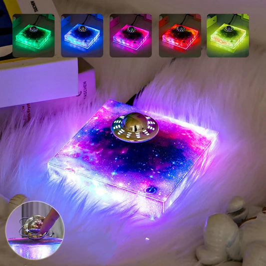 Futuristic levitating UFO lamp with color-changing lights and Milky Way galaxy base