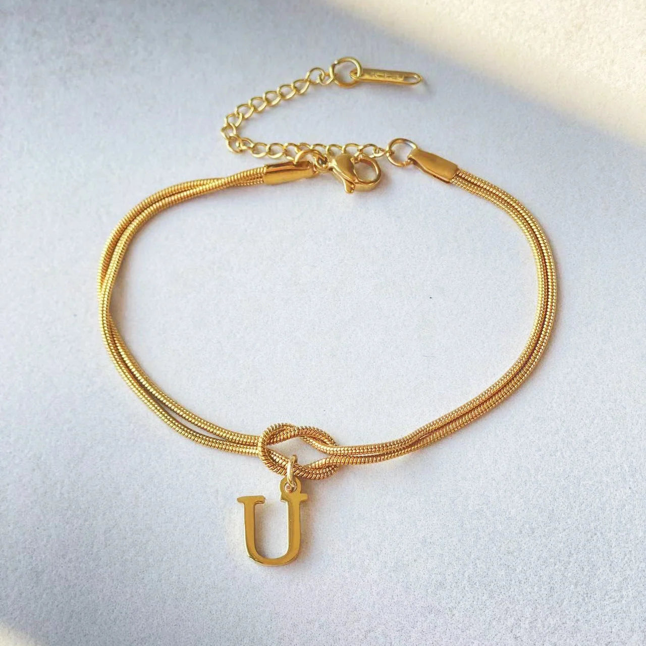 Personalised gold and silver love knot bracelets for couples, perfect as Valentine's Day gifts.