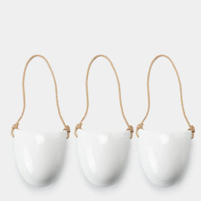 Wall-mounted ceramic flower pot in matte white with hemp rope for balcony gardening