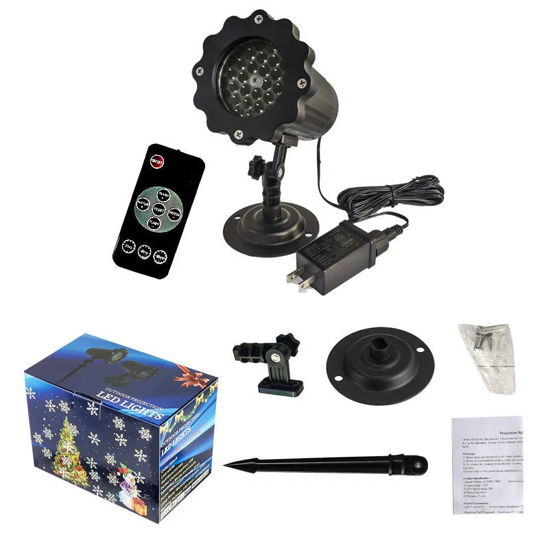 LED Christmas Blizzard Snowflake Laser Light Projector illuminating a garden with white snowflake patterns