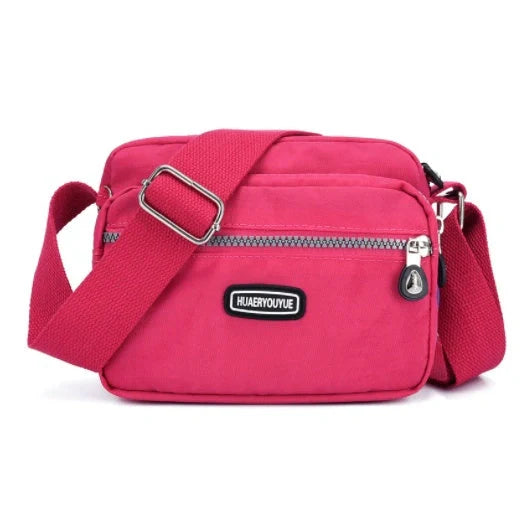 Small square messenger bag in water-repellent nylon with multi-compartment design