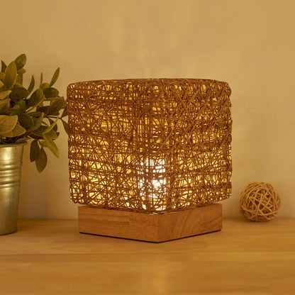 Handcrafted dimmable LED desk lamp made from sustainable rattan and wood, providing adjustable lighting and USB charging for home or office use.