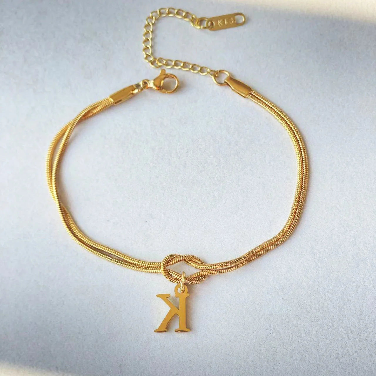 Personalised gold and silver love knot bracelets for couples, perfect as Valentine's Day gifts.