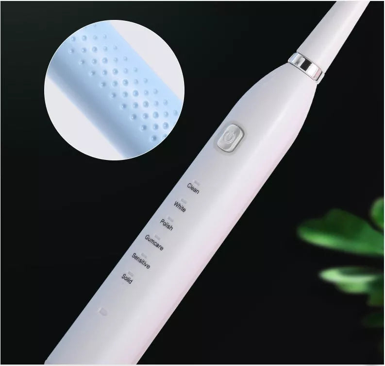 USB charging electric toothbrush in white, pink, and blue with multi-gear vibration