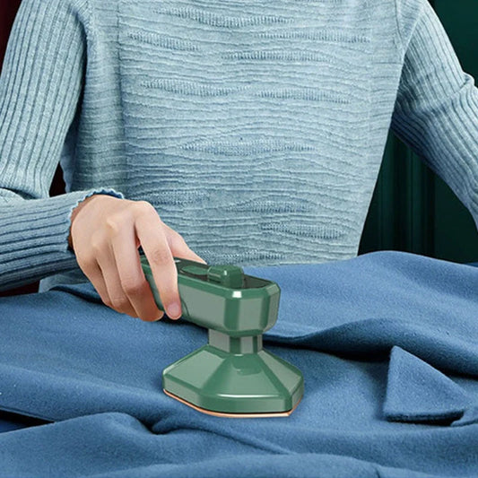 Handheld garment steamer in green, compact and lightweight for easy ironing and cleaning