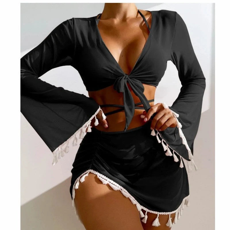 Solid colour bikini set with short skirt and long sleeve cover-up, featuring bow tie and fringe details