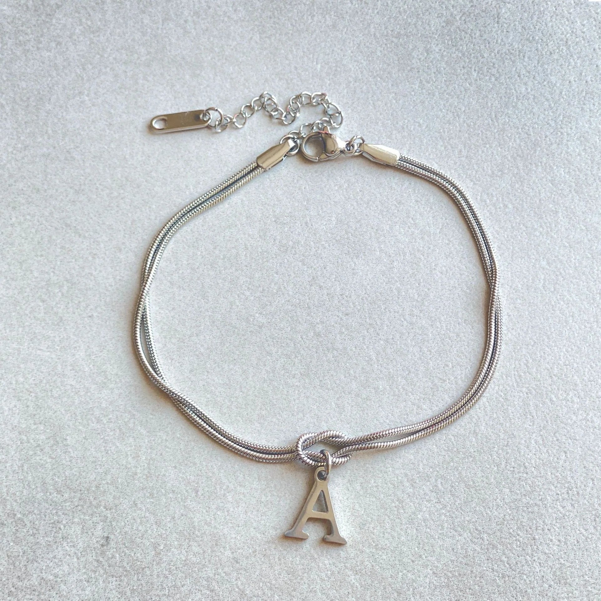 Personalised gold and silver love knot bracelets for couples, perfect as Valentine's Day gifts.