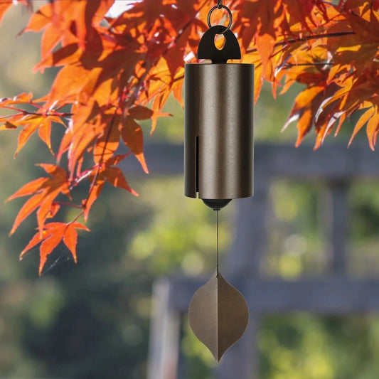 Handcrafted metal wind chimes in black and brown colors, available in small and large sizes, creating a serene outdoor ambiance