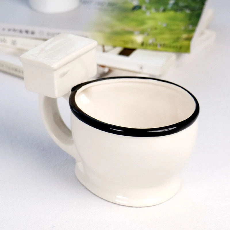 Toilet-shaped ceramic mug with handgrip, perfect for coffee or tea, holding 280ml.