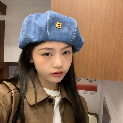 A stylish Japanese-inspired denim beret with a dome-shaped crown and a brimless silhouette, available in light, medium, and dark denim shades.