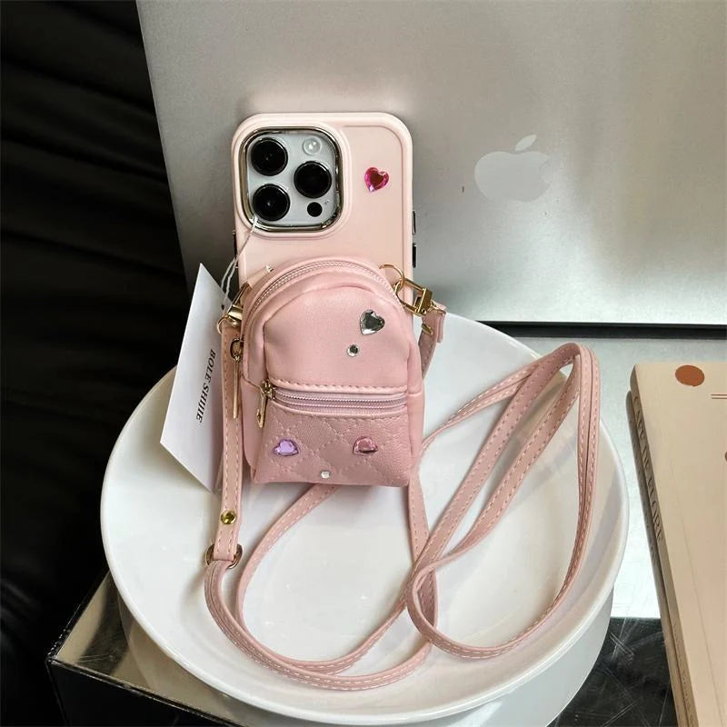 Crossbody wallet phone case for ApplePhone in white, black, or pink with removable shoulder strap
