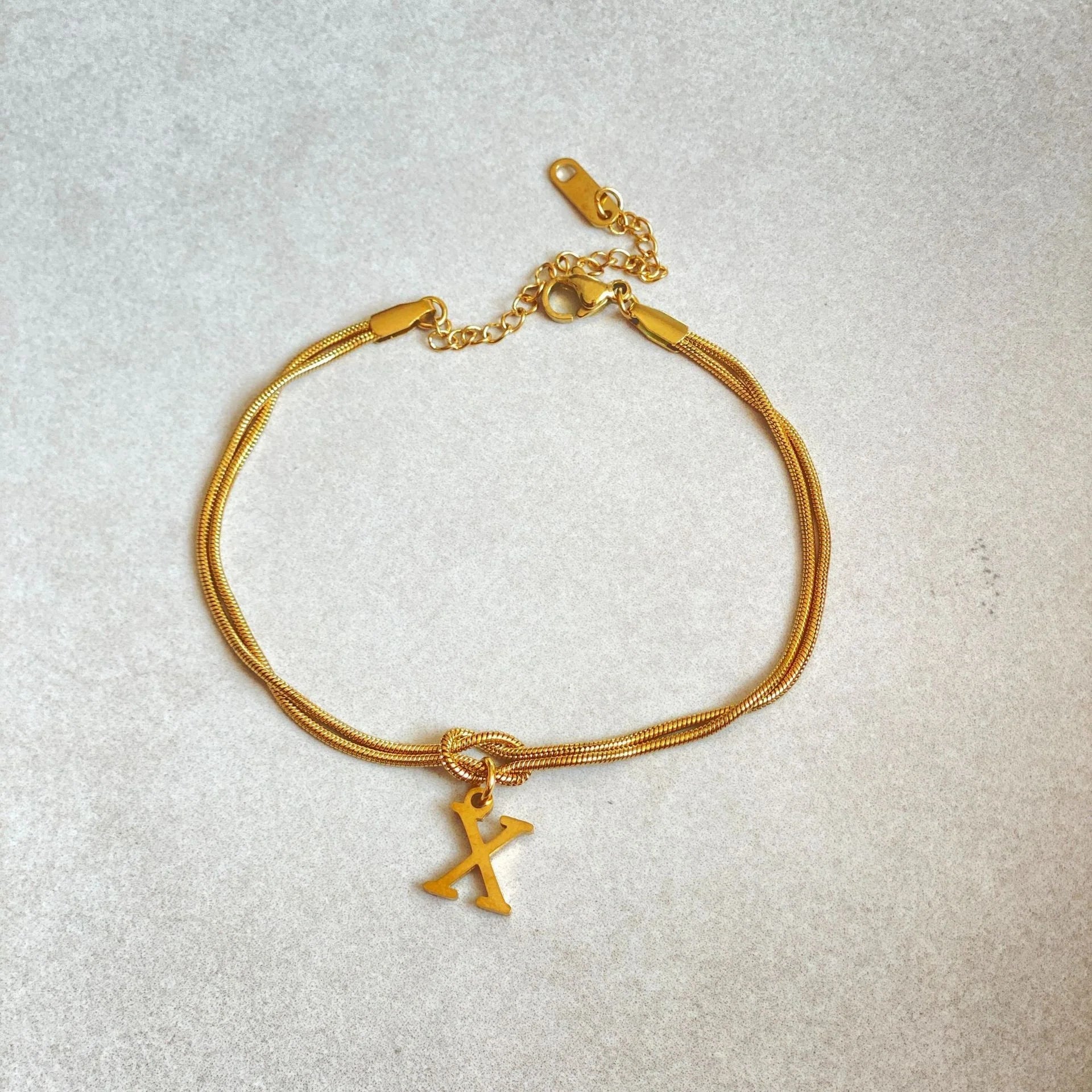 Personalised gold and silver love knot bracelets for couples, perfect as Valentine's Day gifts.