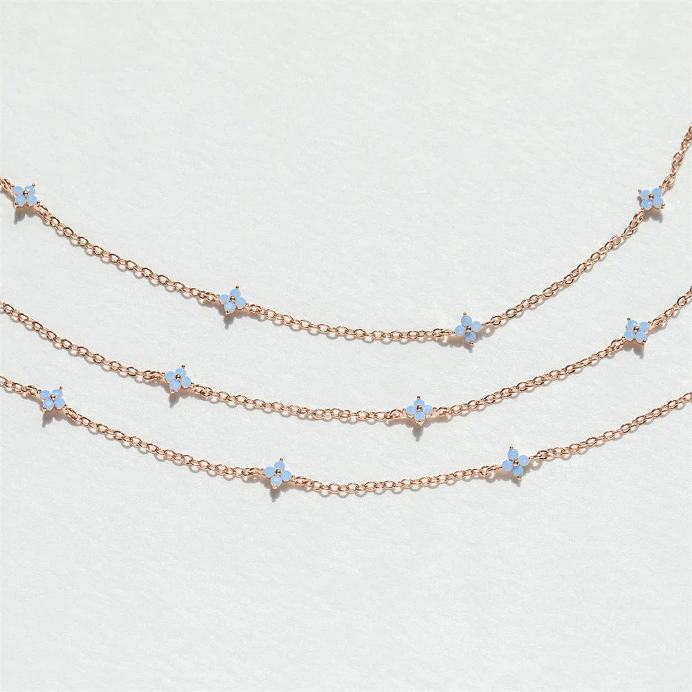 Elegant floral statement necklace in various color options, including golden blue, silver blue, golden green, and silver green, with an adjustable chain and high-quality construction.