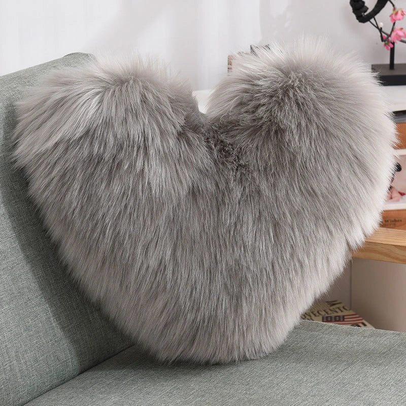 Cozy heart-shaped throw pillow with plush, shaggy texture in various colors