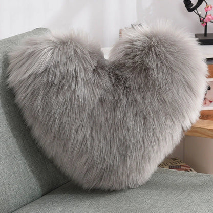 Cozy heart-shaped throw pillow with plush, shaggy texture in various colors