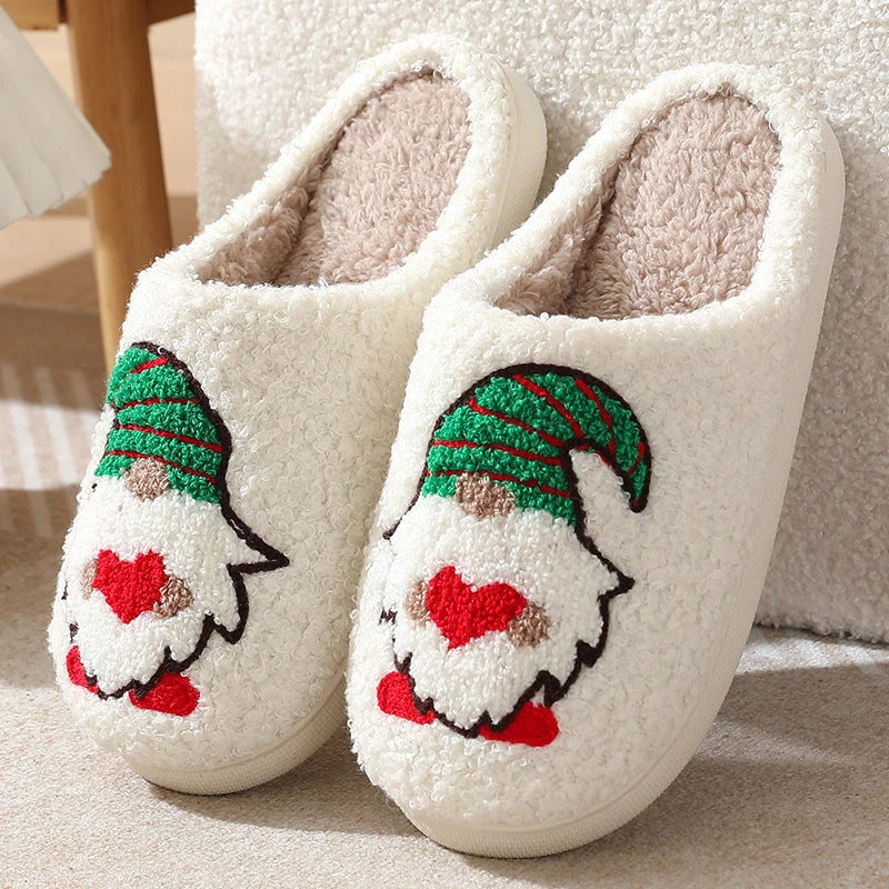 Cozy Christmas-themed slip-on slippers with a charming Santa Claus design, perfect for indoor comfort and warmth during the holiday season.