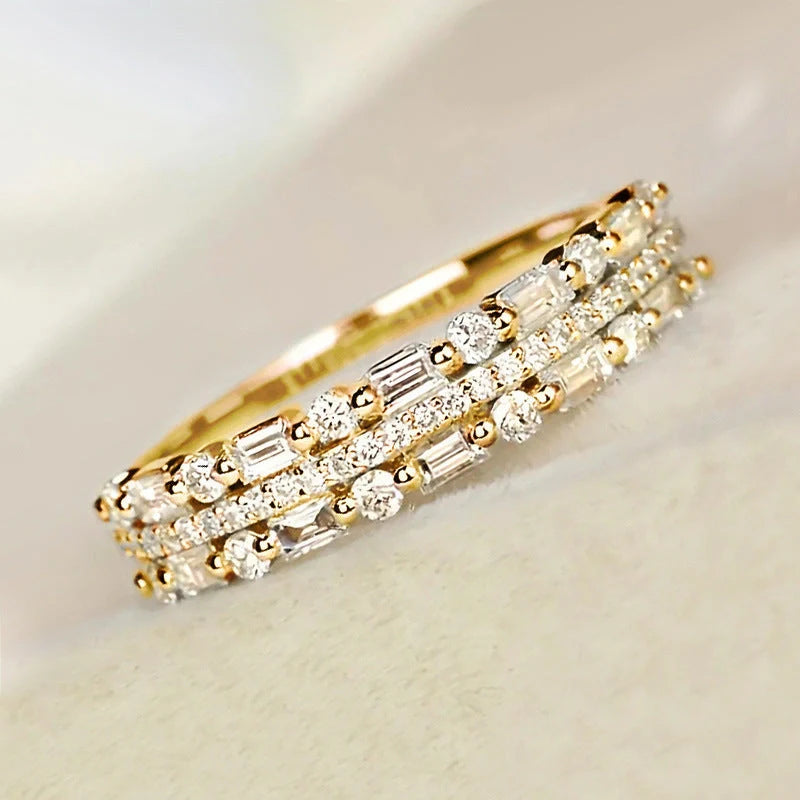 Elegant multilayer ring with a subtle geometric design, available in platinum, gold, and rose gold colours