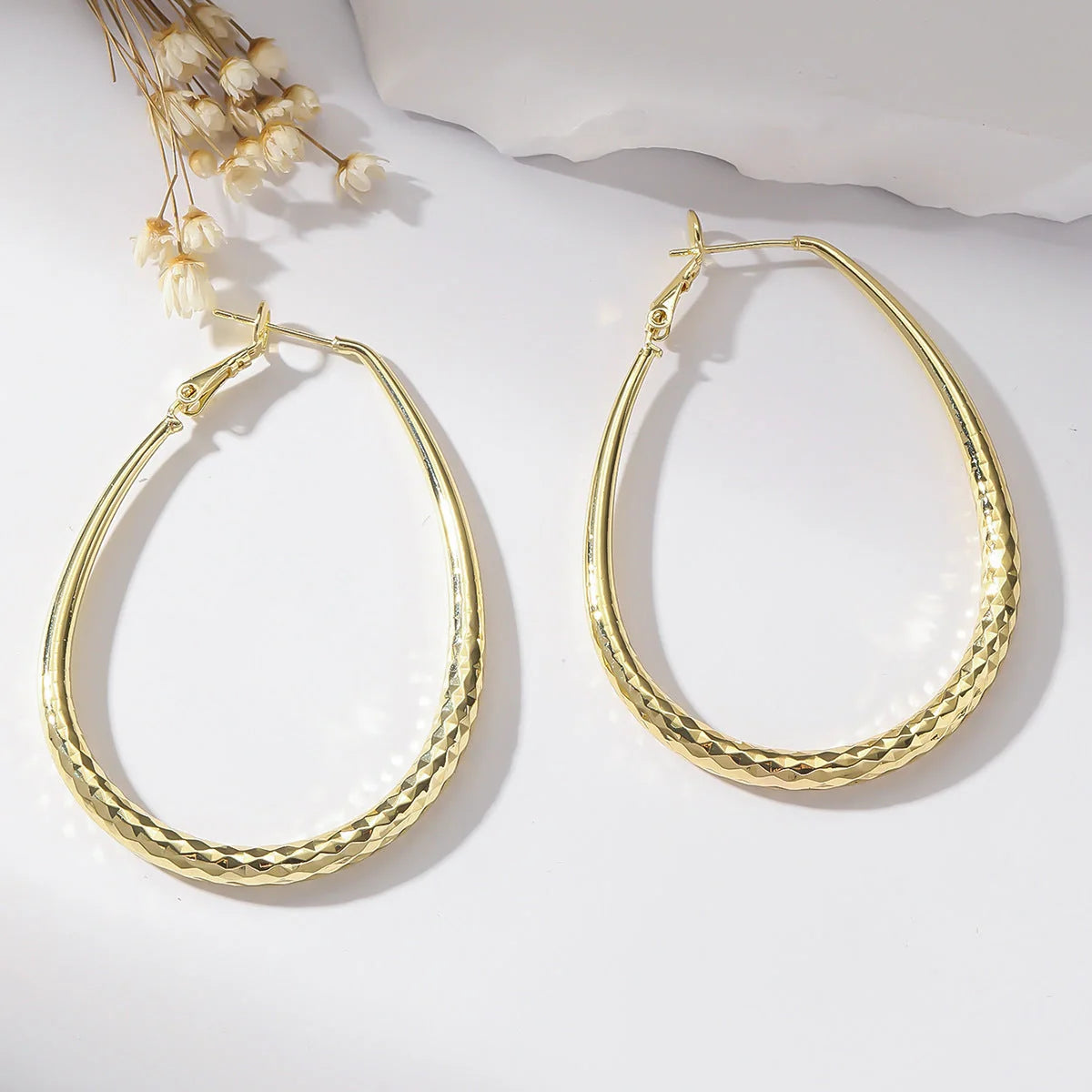 Golden egg-shaped hypoallergenic copper earrings with spring fastener