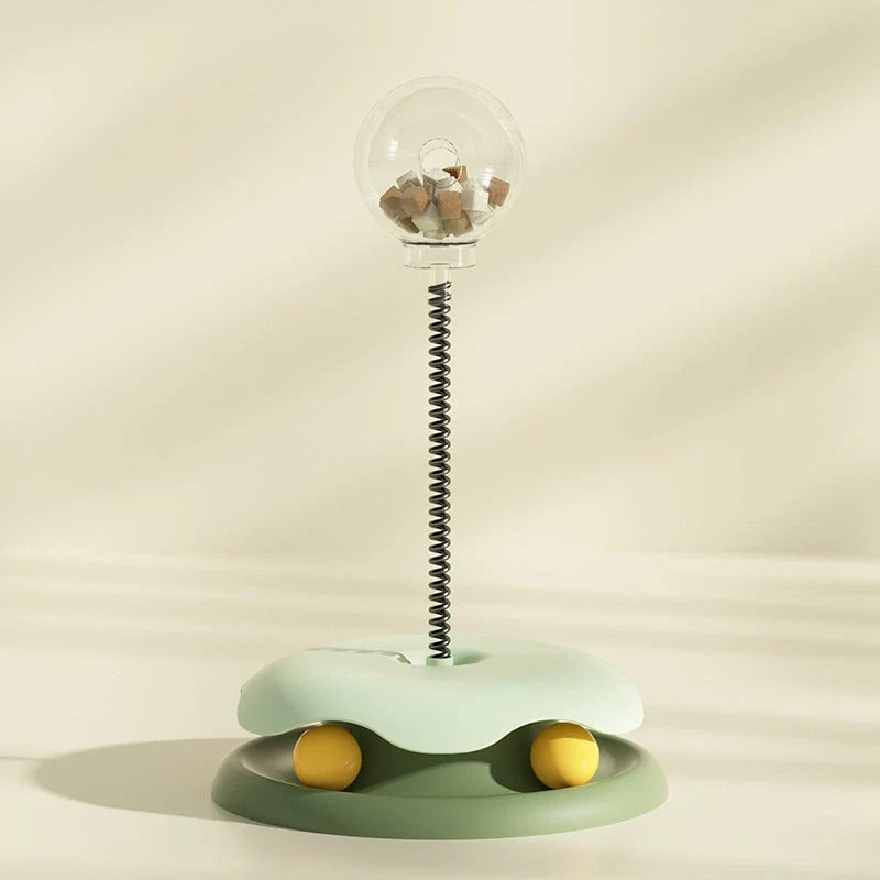 Interactive cat toy with treat dispenser and spring ball in blue, yellow, green