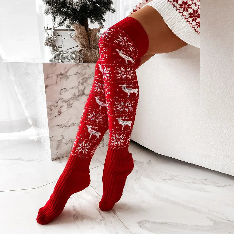 Cozy Christmas knee-high socks for women featuring a festive snowflake and reindeer pattern, designed to provide warmth and comfort during the winter season.