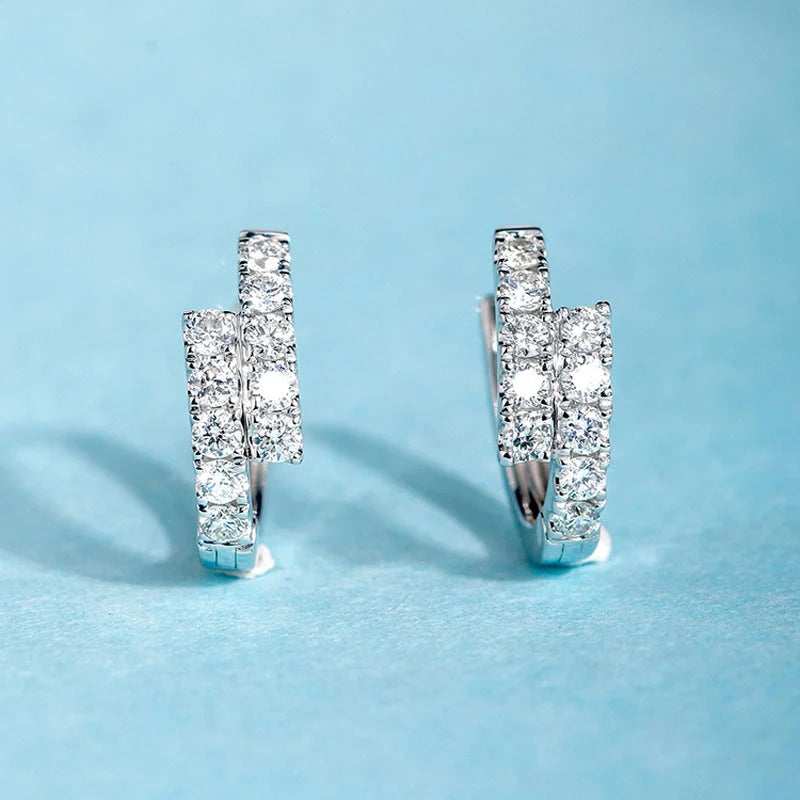 Elegant diamond-accented ear clips with a geometric design, showcasing refined British style.