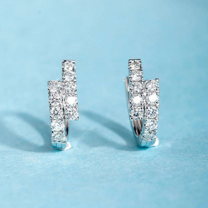 Elegant diamond-accented ear clips with a geometric design, showcasing refined British style.