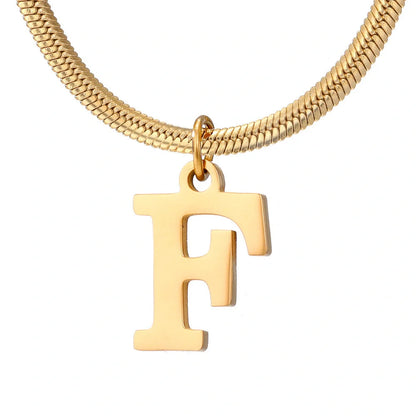 Gold-coloured A-Z letter pendant necklace on a snake chain