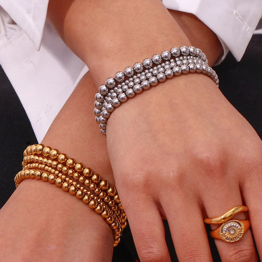 Vintage-inspired stainless steel and 18K plated elastic bead bracelet in a range of sizes and colours