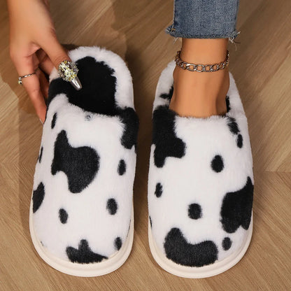 Cozy cow print plush slippers with a non-slip sole, perfect for indoor comfort and warmth