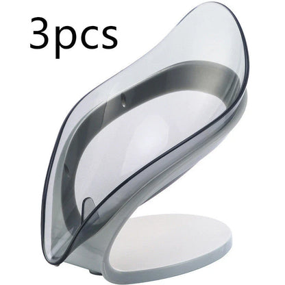 Elegant leaf-shaped soap dish with self-draining design and stable triangular shape, made of durable ABS material
