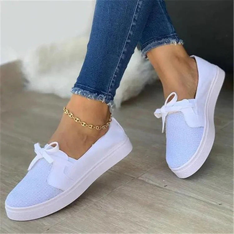 Women's white lace-up canvas flat shoes with cross straps