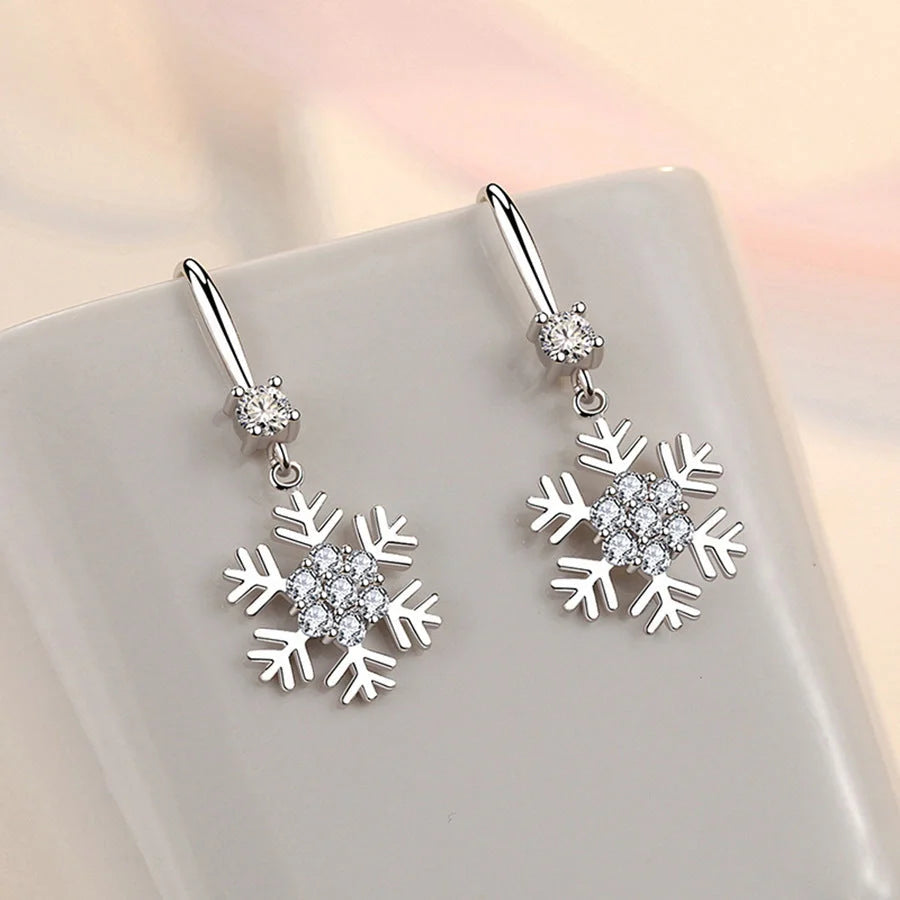 Elegant snowflake earrings with sparkling rhinestones, a festive fashion accessory for women