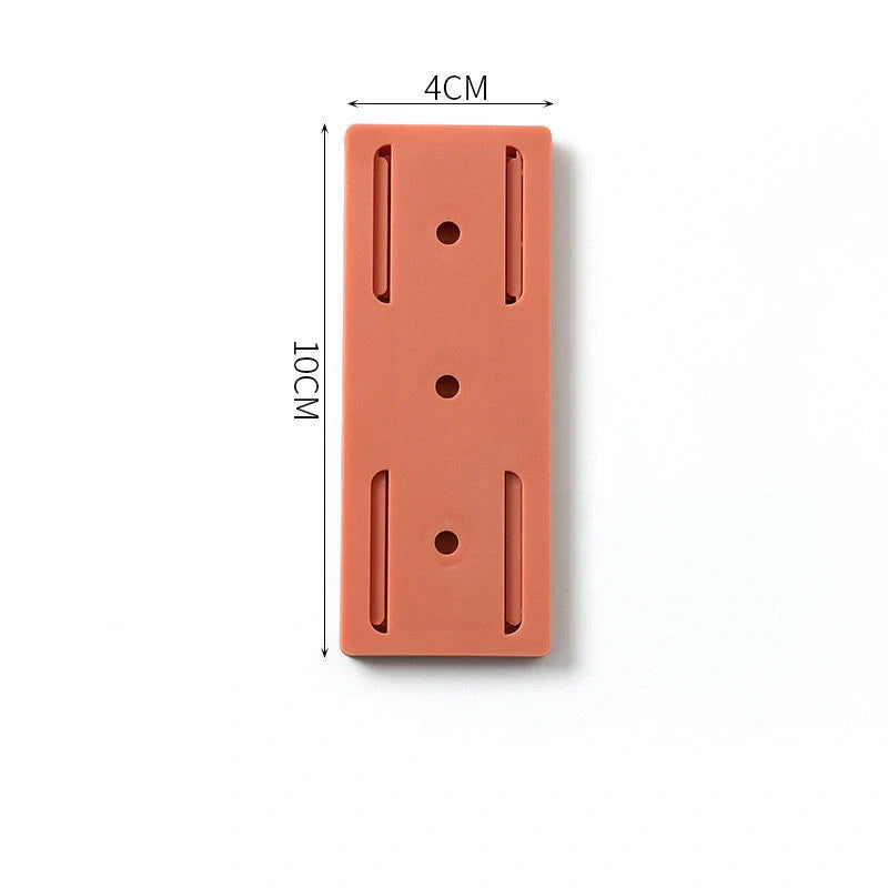 Self-adhesive wall hook in green, blue, white, and pink for cable organisation